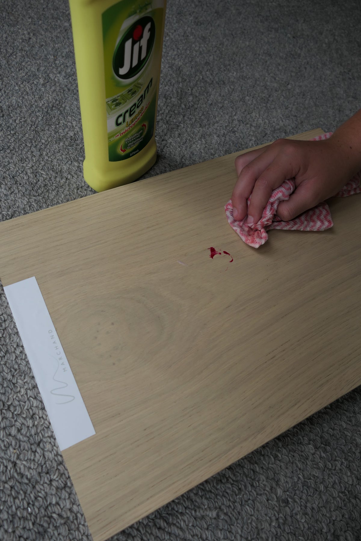 Marchand Test Lab: dried red nail polish almost fully removed from a Blanc Oak board with Jif cream cleanser