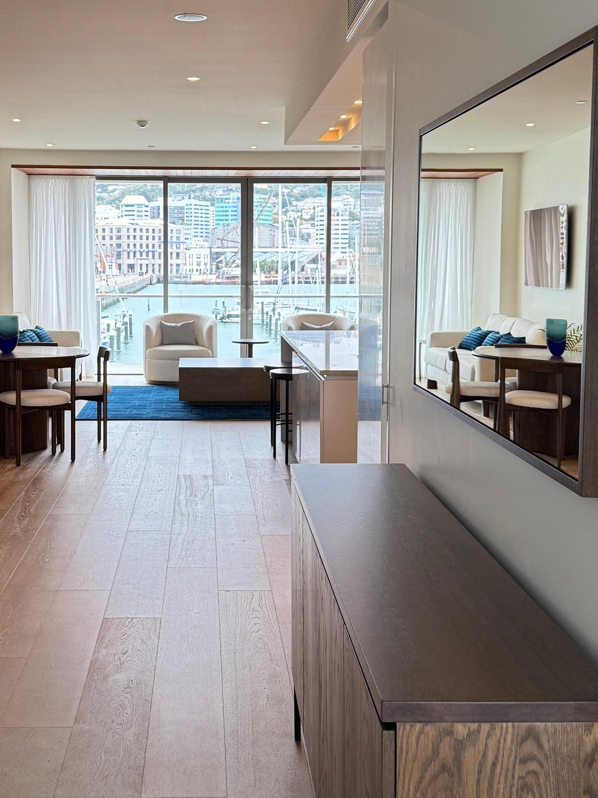 La Forêt Oak flooring running through the link space of a Clyde Quay Wharf penthouse, Wellington, with the marina and city beyond