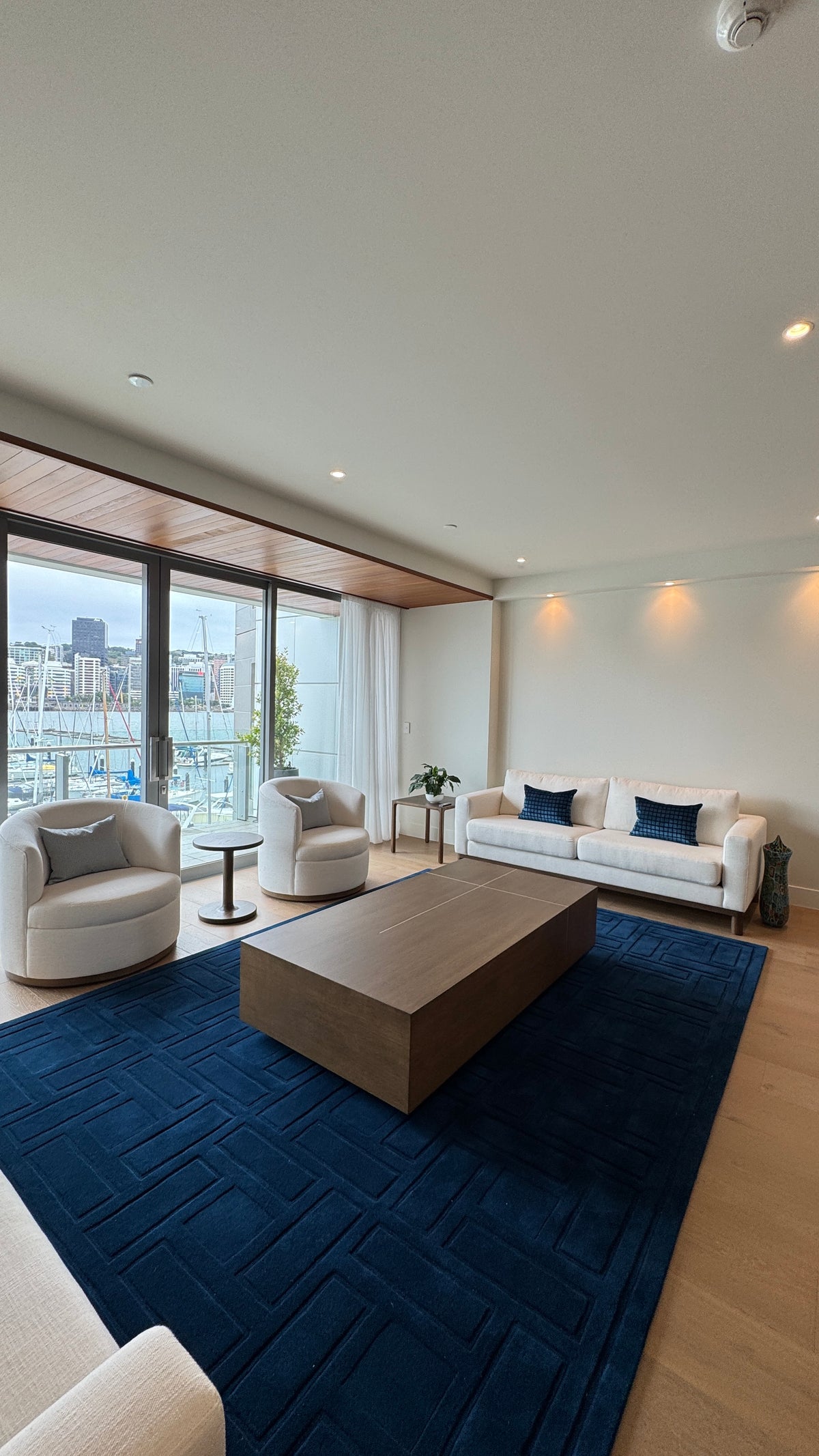 La Forêt Oak flooring around a blue wool rug in a Clyde Quay Wharf penthouse living room, Wellington