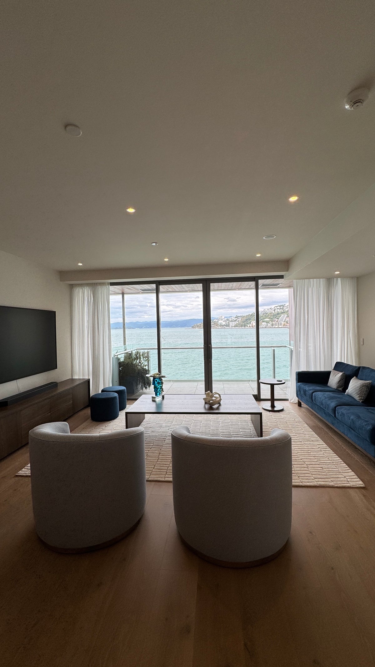 La Forêt Oak flooring in the main living room of a Clyde Quay Wharf penthouse, with Wellington harbour through full-height glazing