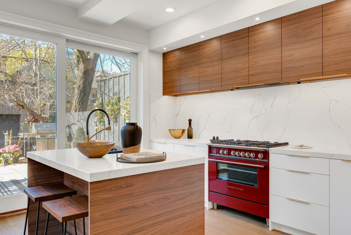 Flat-front timber veneer kitchen cabinetry in the mid-century manner. Reference photograph by André François McKenzie via Unsplash