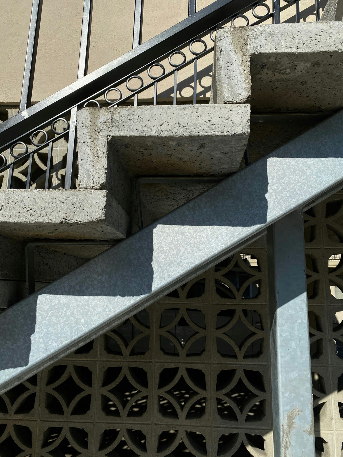 Breeze block screen and cantilevered concrete stair, mid-century detail. Reference photograph by Susan Gold via Unsplash